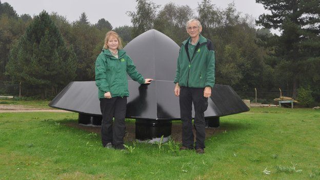 Olivia English and Nigel Turner with the Rendlesham Forest UFO sculpture