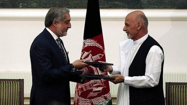 Abdullah Abdullah (left) and Ashraf Ghani exchange signed agreements. 21 Sept 2014