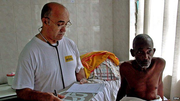 An undated handout photo released by Spanish aid organisation Juan Ciudad ONGD, shows Spanish doctor and missionary Manuel Garcia Viejo (L) working at the San Juan de Dios Hospital in Lunsar, Sierra Leone