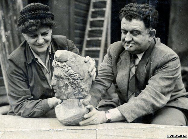 Two people holding up the newly discovered head of Mithras, 1954