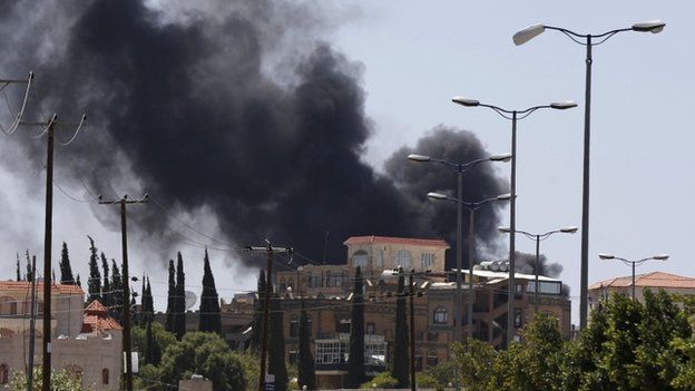 Smoke rises from an area where Shia Houthi rebels are fighting against government forces in Sanaa on 21 September 2014.
