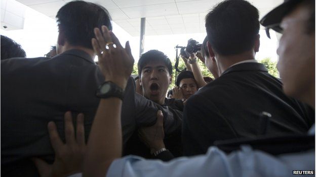 Police stop student protesters as they rush to meet Chief Executive Leung Chun-ying at government headquarters in Hong Kong 23 September 2014.