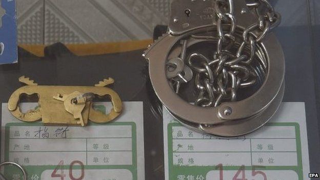 Finger and cuff restraints on sale in a security equipment shop in Beijing on 19 September 2014