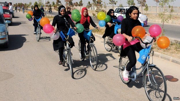 Afghan girls participate in a bicycle race to mark World Peace Day in Mazar-e-Sharif, (21 September 2014)