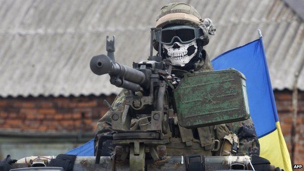 A Ukrainian serviceman wears a mask depicting a skull on armoured personnel carrier in Debaltseve. Photo: 23 September 2014