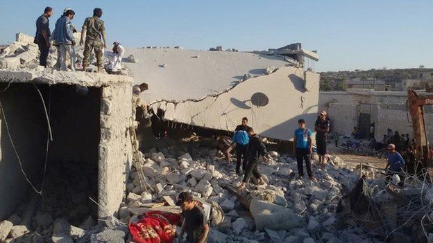 Residents of the Syrian village of Kfar Deria survey the damage after US missile strikes targeting the Khorasan Group (23 September 2014)