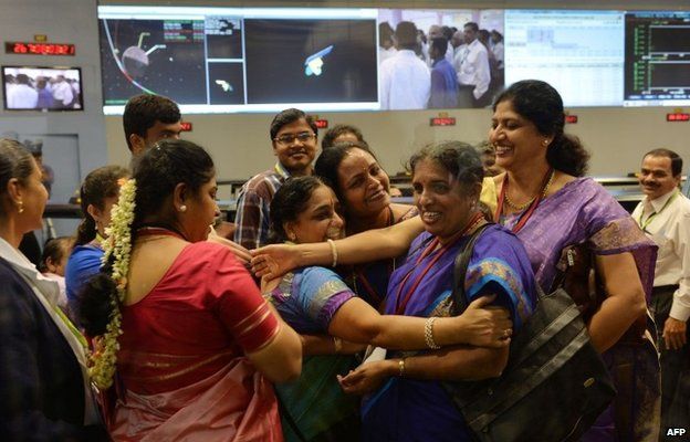 Indian staff from the Indian Space Research Organisation (ISRO) celebrate after the Mars Orbiter Spacecraft (MoM) successfully entered the Mars orbit