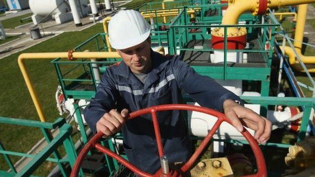 Darshava gas facility in Ukraine, man with manual wheel operating valve