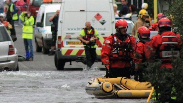 Fire crews used a dinghy to rescue people from their homes in Kingswood after a burst water main