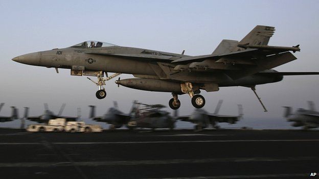 Fighter jet coming from Iraq lands on US aircraft carrier USS George HW Bush, in the Gulf. 10 Aug 2014