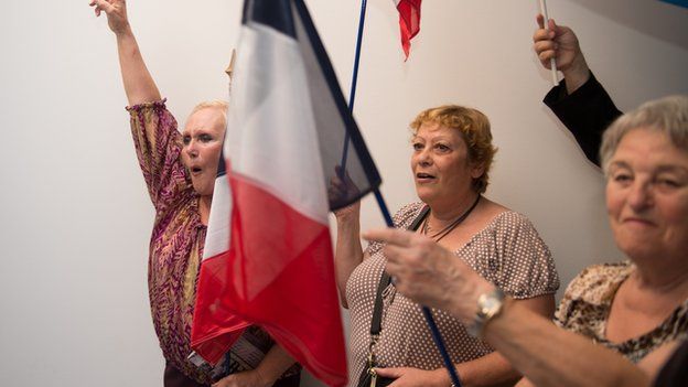French far right party Front National (FN) new senator Stephane Ravier's supporters celebrate on September 28, 2014 in Marseille, southern France, after the results of the French Senate elections.