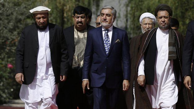 Chief Executive Abdullah Abdullah, center, arrives for an inauguration ceremony at the presidential palace in Kabul, Afghanistan, Monday, Sept. 29, 2014.