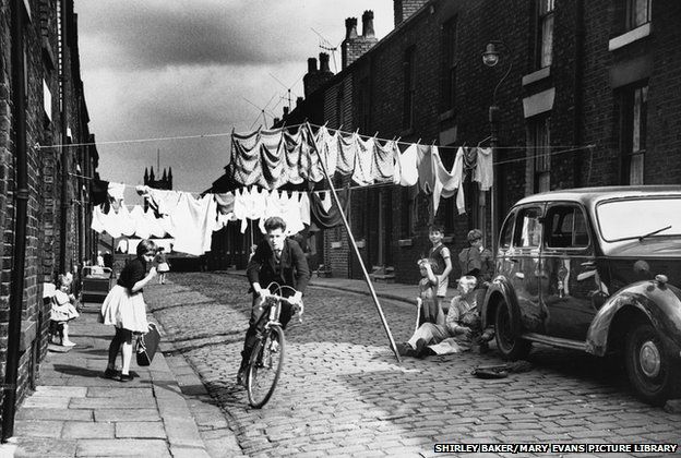 Cycling along a terraced street, Salford, Manchester 1962