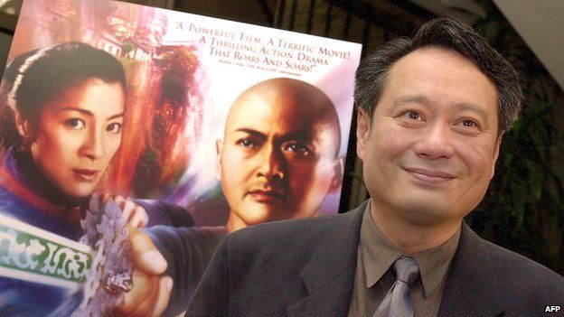 Director Ang Lee poses in front of a poster of his Oscar-winning "Crouching Tiger, Hidden Dragon"
