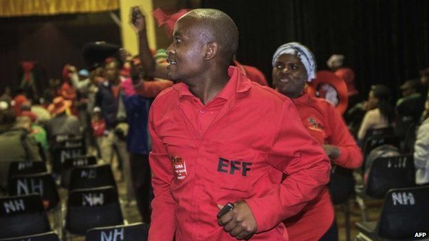 An Economic Freedom Fighters' supporter sings and dances as he attends a vigil in support of the party's leader Julius Malema on the eve of his trial on charges of corruption on September 29, 2014 in Polokwane.