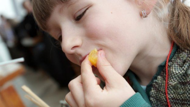 Child eating orange segment