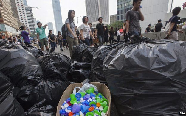 Plastic bottle tops are seen separated for recycling by students