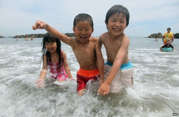 Children playing in the sea in Japan
