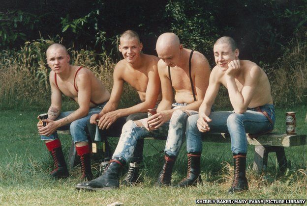 Four skinheads sit on a bench in a Wilmslow Park