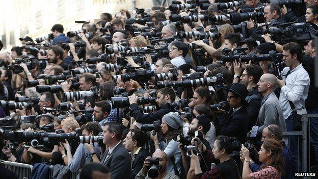 Photographers work during the Chanel show