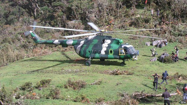 A handout photo released by the "Espeleo Club Andino del Peru" cave research organization and made available on 26 September 2014 showing a Peruvian Air Force helicopter helping in an operation to rescue Spanish speleologist Cecilio Lopez Tercero from a cave near Leymabamba, a remote area in the Amazonas region, on 25 September 2014