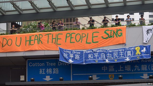 Banners designed by pro-democracy demonstrators hang from an overpass across Hong Kong's government offices, on the fourth day of the mass civil disobedience campaign Occupy Hong Kong, Admiralty, Hong Kong, China on 1 October 2014