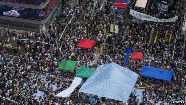 Buses covered with messages of support stop at a main street at Mong Kok shopping district after thousands of protesters blocked the road in Hong Kong on 1 October 2014.