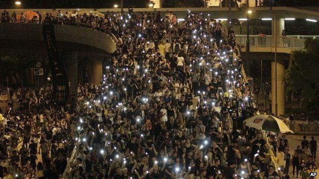 Tens of thousands of protesters stand in the streets of of Hong Kong on 1 Oct
