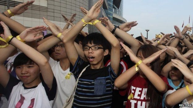 Joshua Wong (centre) and supporters chant during a flag raising ceremony in Hong Kong on 1 Oct
