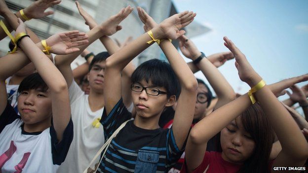 Student pro-democracy group Scholarism convenor Joshua Wong (C) makes a gesture at the Flag Raising Ceremony on 1 October 2014 in Hong Kong
