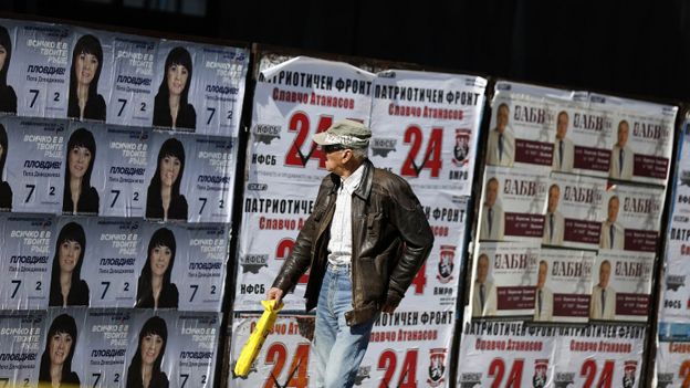 Man walks past election posters in Plovdiv