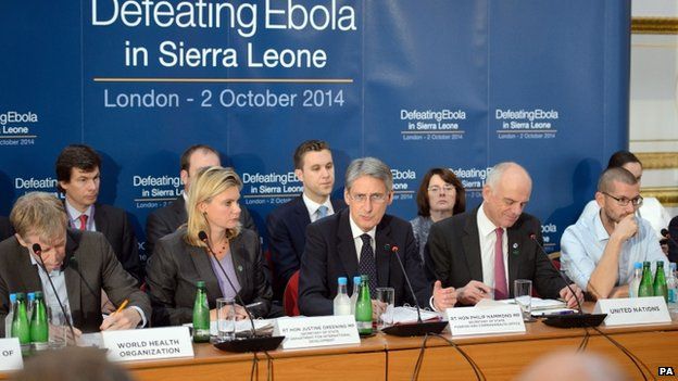 Foreign Secretary Philip Hammond (fifth right) addresses delegates at the "Defeating Ebola in Sierra Leone" conference at Lancaster House in London on 2 October 2014
