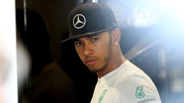 Lewis Hamilton of Great Britain and Mercedes GP looks on from the team garage during practice for the Japanese Formula One Grand Prix at Suzuka Circuit.