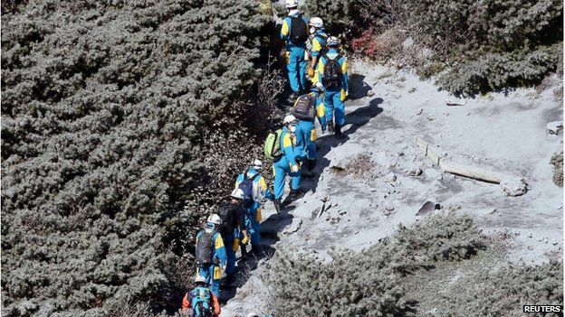 Rescuers climb up Mount Ontake, which straddles Nagano and Gifu prefectures, for rescue operations, central Japan, 2 October, 2014, in this photo taken and released by Kyodo
