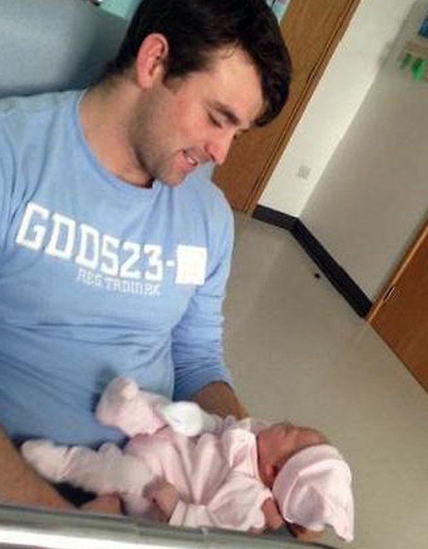 Thomas Ward and his newborn daughter