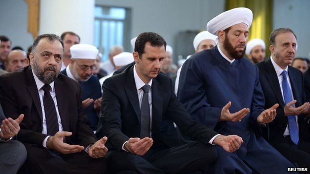 Syrian President Bashar al-Assad seen praying in the al-Numan bin Bashir mosque in Damascus - Syrian news agency handout from 4 October