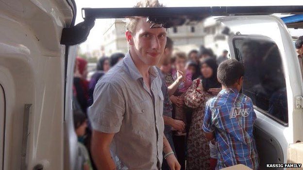 An undated photo provided by Kassig family shows Abdul-Rahman Kassig standing outside a truck of supplies for Syrian refugees.