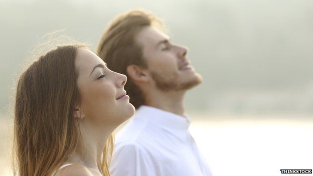 A man and woman looking up to the sky with a calm look on their faces