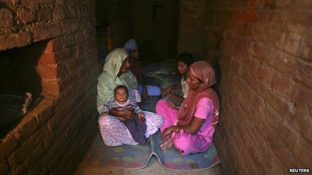 Indian villagers take shelter inside an army bunker at Devi Garh village near Jammu October 7, 2014.