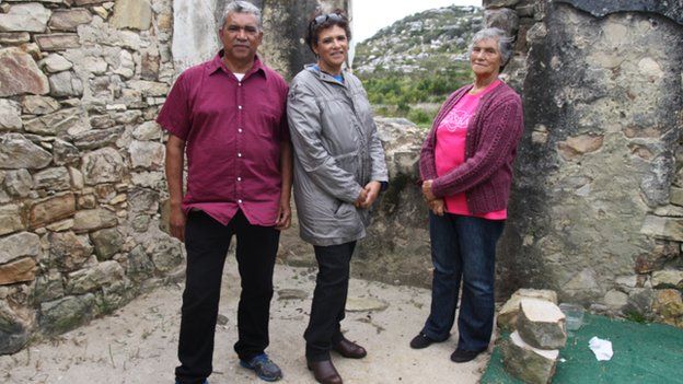Lily Lawrence with her children at the ruins of their home in South Africa (October 2014)