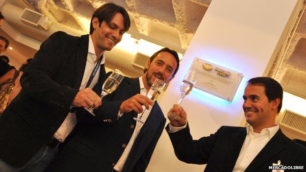 Marcos Galperin and colleague toast the launch of the firm's new Sao Paulo office in 2011