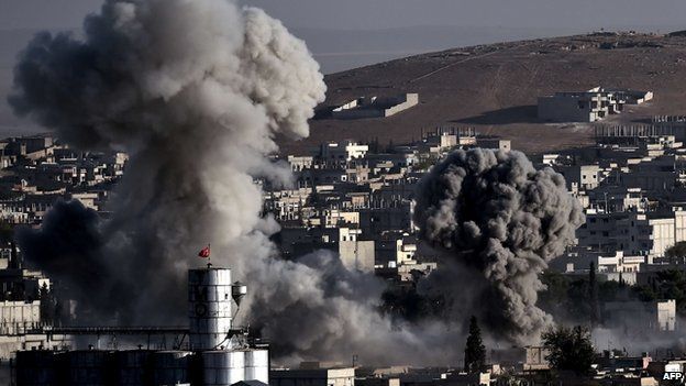 Smoke rises after strikes from the US-led coalition in the Syrian town of Kobane on 10 October 2014.