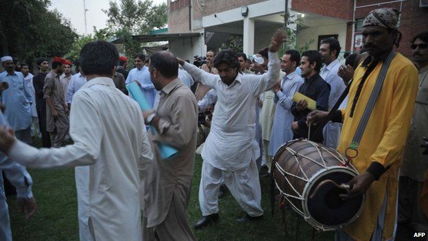Pakistani NGO activists dance in celebration
