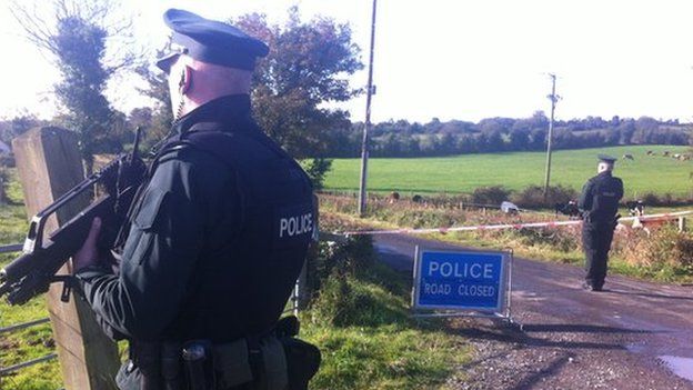 Police guard the outer cordon of security operation