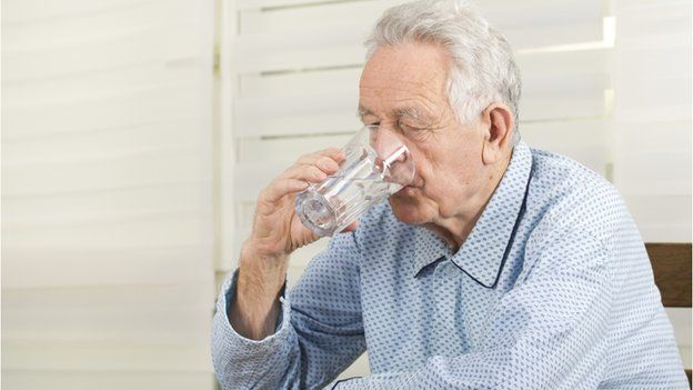 Older man drinks water