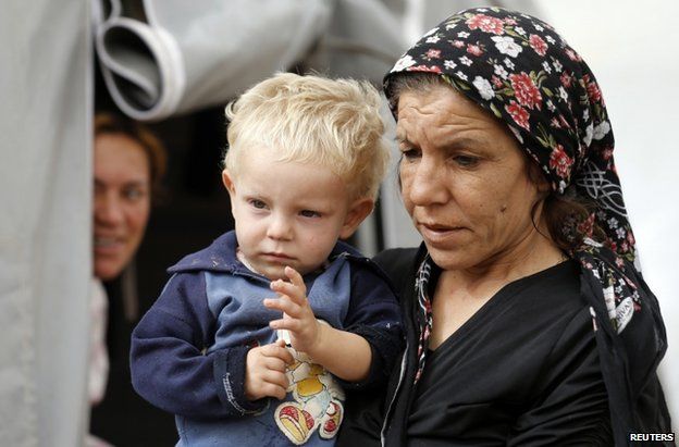 A Syrian Kurdish refugee and her child at a camp in Suruc, Turkey, 11 October