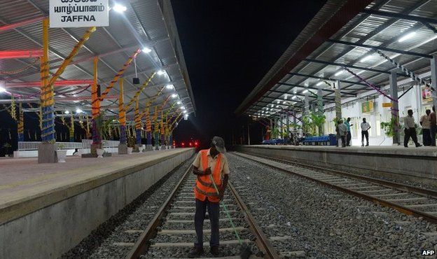 A Sri Lankan labourer cleans the tracks at the Jaffna railway station the capital of Sri Lankas northern province, 12 October 2014