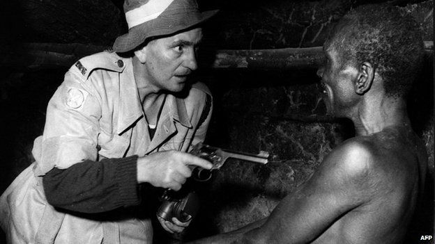 A night raid organised by the colonial army and police in Kenya to find members of the Mau Mau (1952)