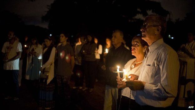 People participate in a candlelight vigil against violence in Cali on 8 October, 2014