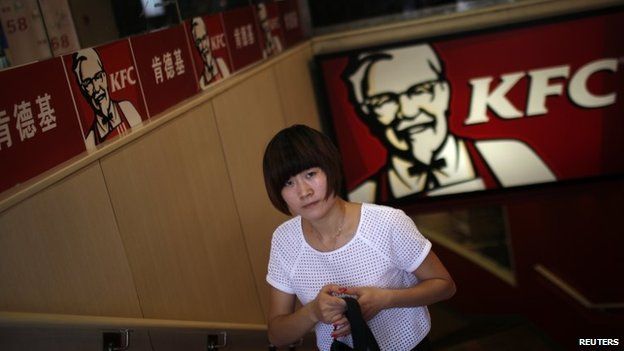 A customer walks out of a KFC store in downtown Shanghai on 31 July 2014
